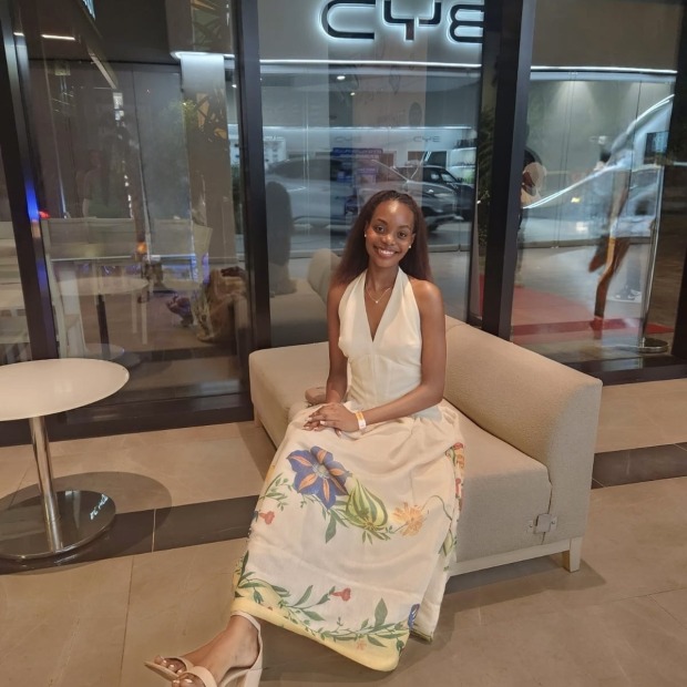 Jeanne-Marie sits and smiles at the photographer