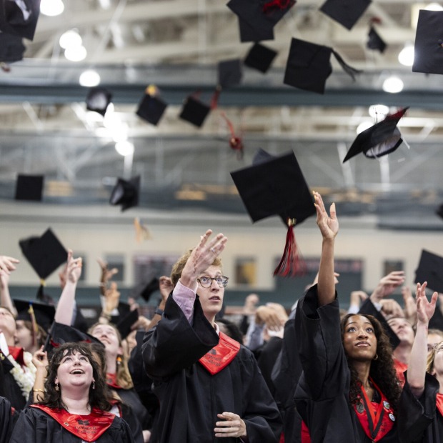 2026 Grinnell graduates throw their caps into the air at commencement