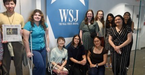 students near a wall street journal sign