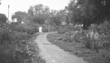 Girl stands on a path in the botanical garden