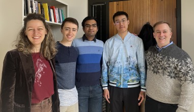 A group of two faculty members with three students
