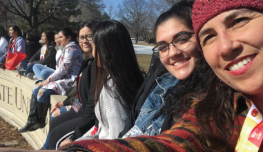 Kristin Stuchis in a group of other women sitting outside