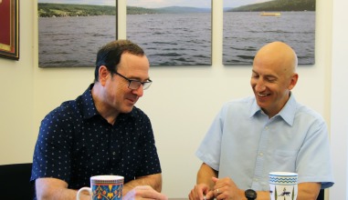 Marc Chamberland and Jeff Blanchard working at a table