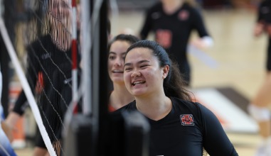 Volleyball players smile on the court