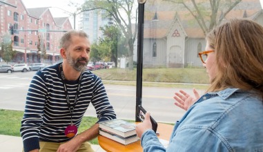FilmScene cofounder Andrew Sherburne '01 speaks with Iowa Public Radio reporter Nicole Baxter during Refocus Film Festival.