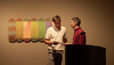 James Snyder '26 (left) receives the Henley Best in Show Award from Andrew Kaufman, department chair of Studio Art. 