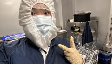 Christine Ko '28 in the lab attire required for her research at the University of Iowa's Optics and Astronomical Technologies (OAT) Lab.