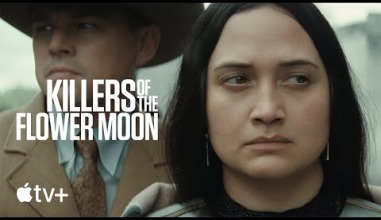 A close up of an Indigenous woman's face, who looks seriously off into the distance. On her left is white text that says, "Killers of the Flower Moon."