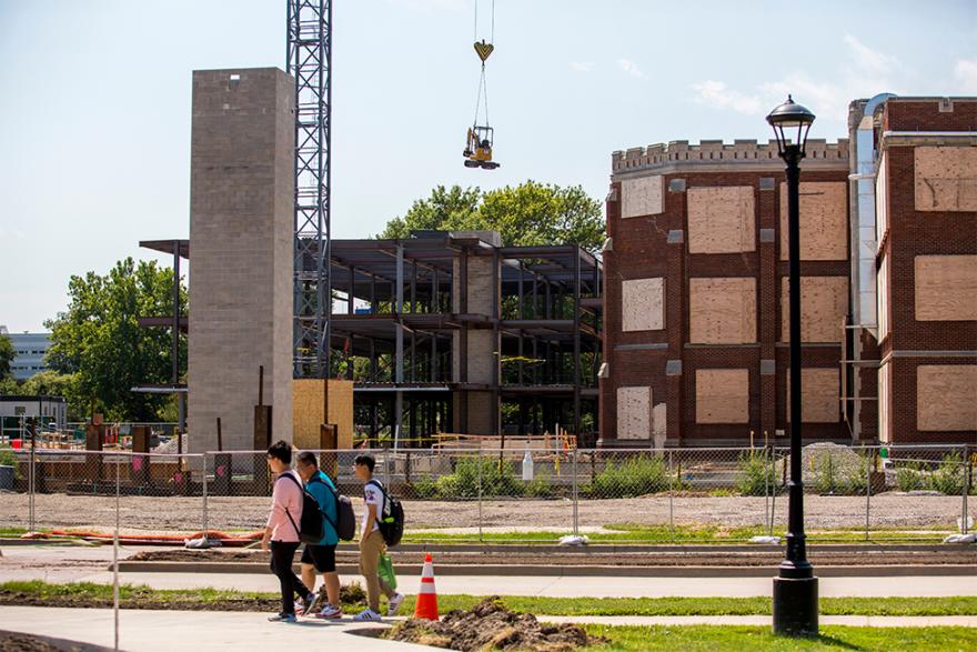 Construction site of Humanities and Social Studies Complex, boarded up windows on ARH, steel beam structure in place