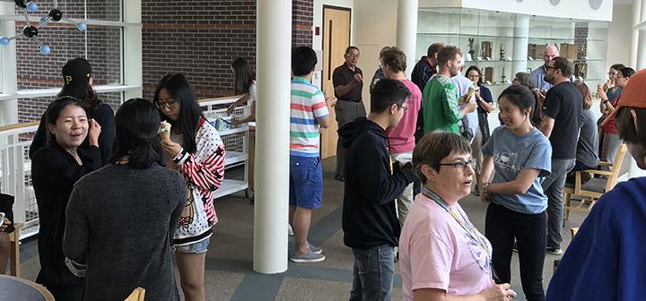 Mingling people at the chemistry ice cream social.