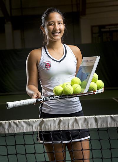 Anushka Joshi ’18 holds tennis racket with book, balls balanced on top