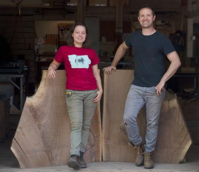 Tor and Isabella standing in front of wood slab