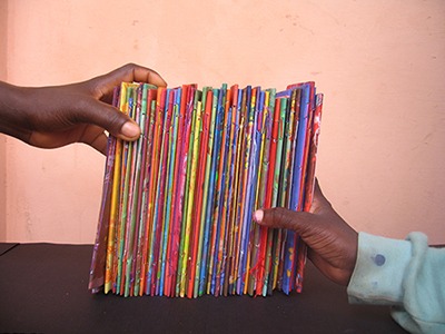 Hands bookending a group of handmade books