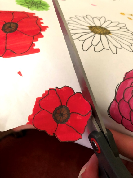 Using scissors to cut out a flower
