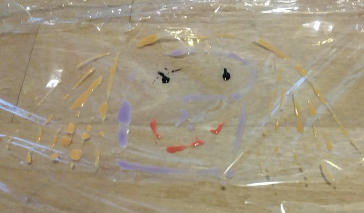 Watercolor painting of a face on plastic wrap