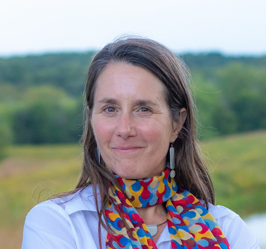 Lisa Schulte Moore outside with prairie in the background