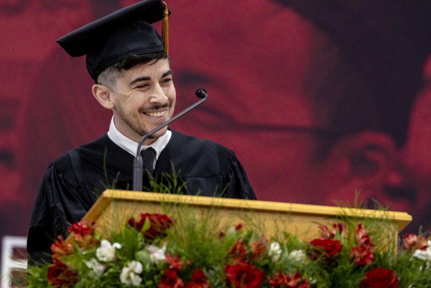 Chase Strangio ’04 wearing black graduation regalia