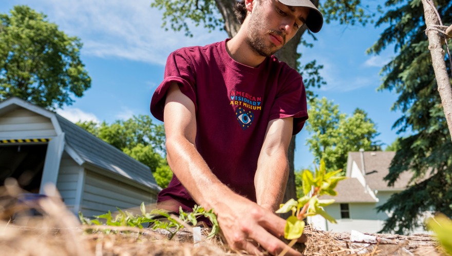 Jacob Friedman plants a seedling in the garden