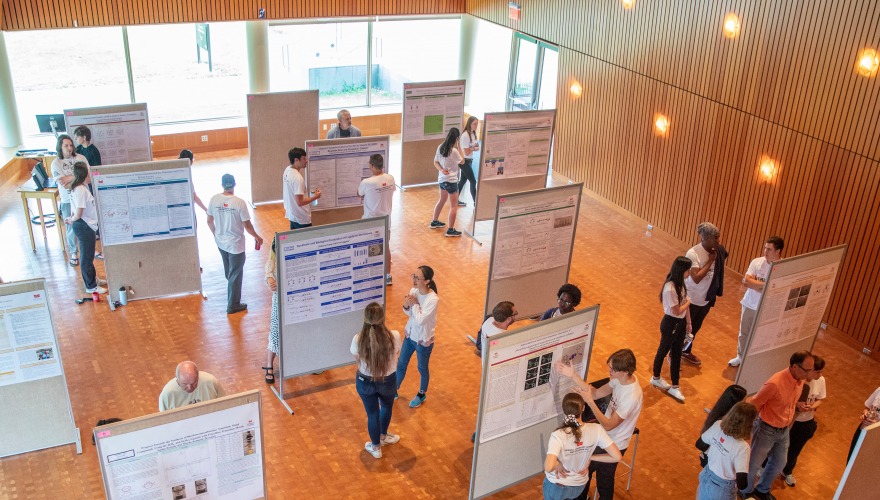 Students present their research posters to faculty and guests. 