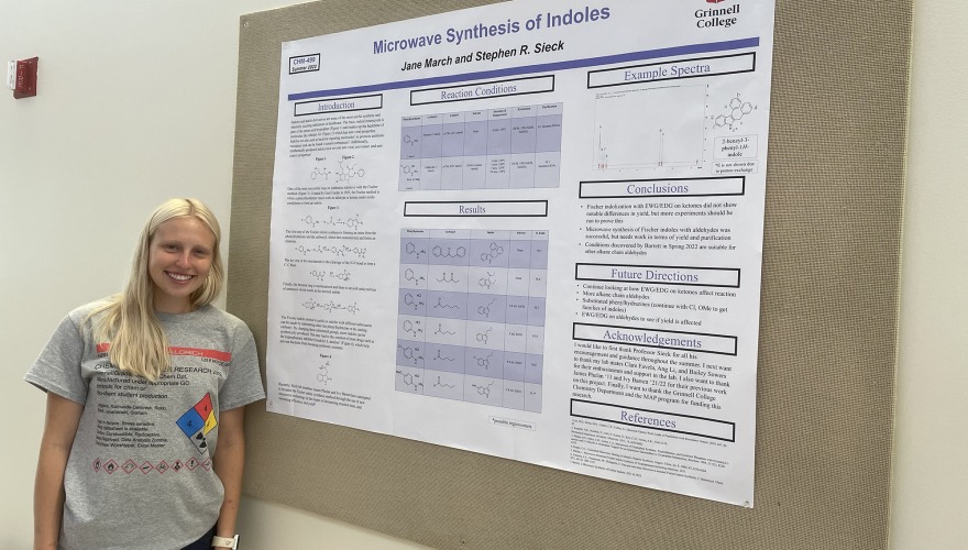 Jane March stands beside her research poster.