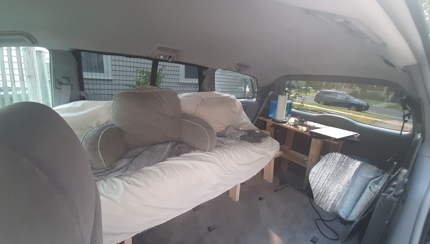 The interior of Brian's van, complete with futon and solar panels.