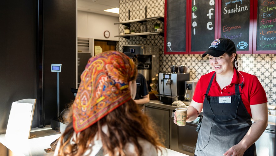 employee serving coffee to customer 