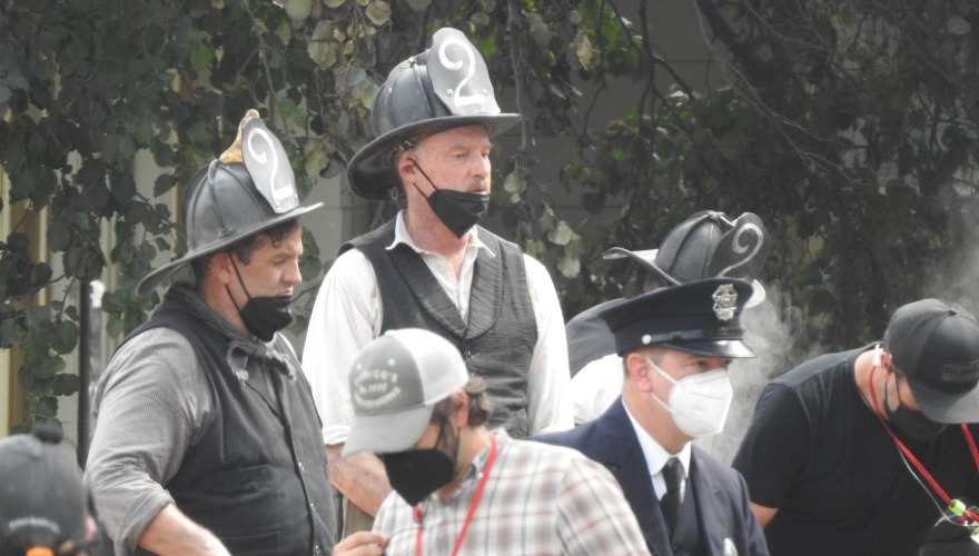 A bunch of firemen extras with masks on the set of the movie.