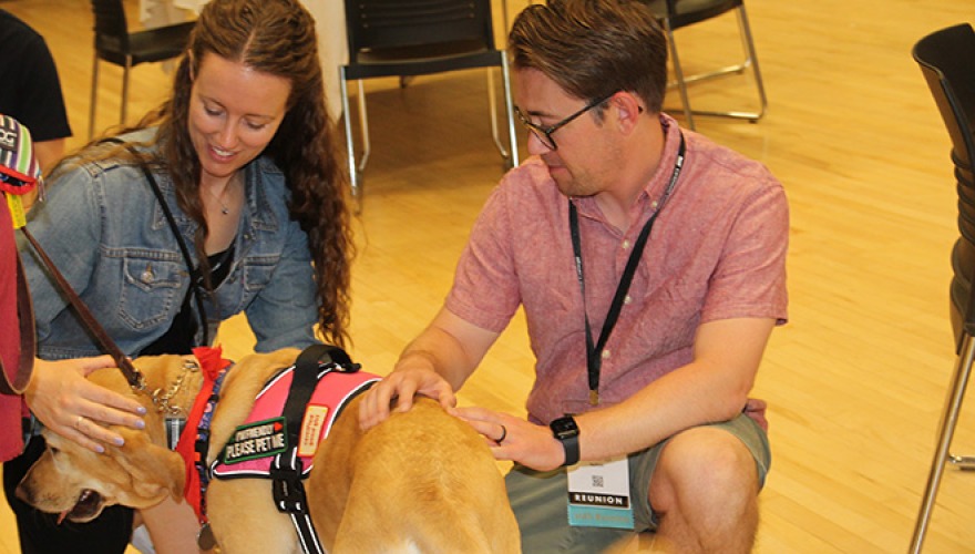 Jordan Schellinger '15 and friend with a support dog at Grinnell's Reunion 2025