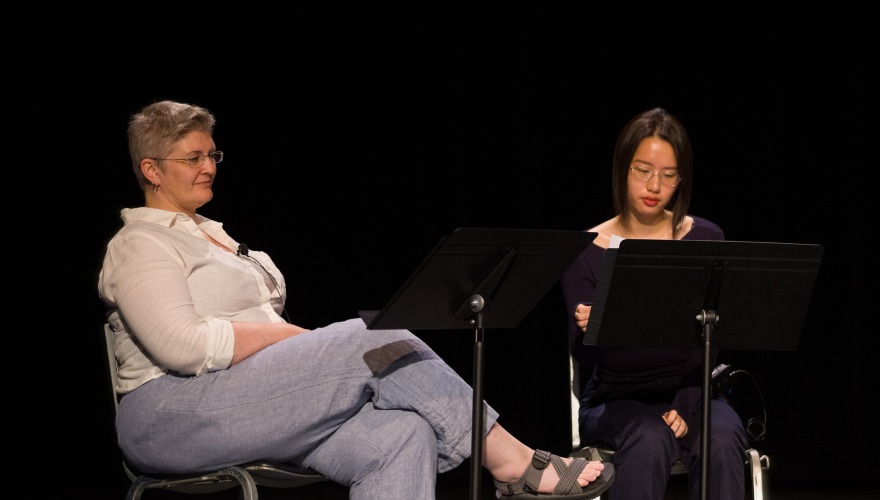 Amy Mi ’28 sitting to the right of Tisha Turk who sits with her legs crossed 