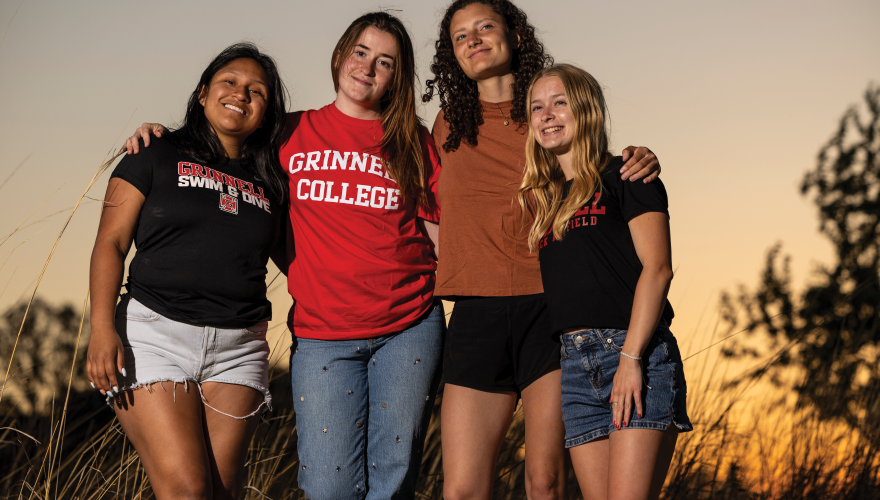 Eleanor Elliott-Rude with three other women against a twilight sky