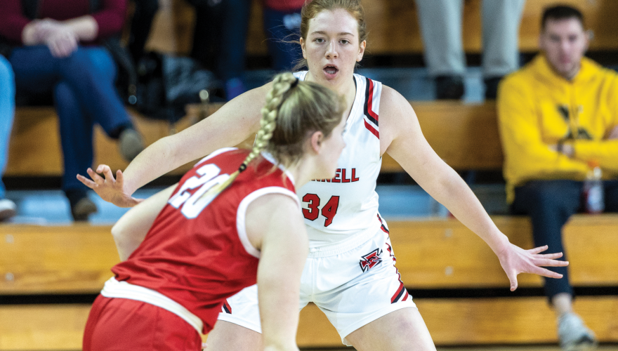 Sarah Booher guards an opposing team member who has the basketball