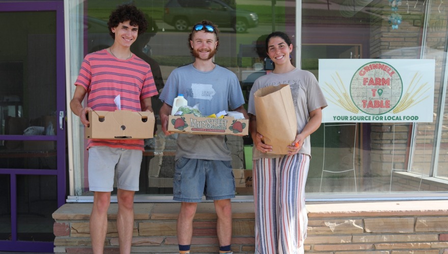 three people outside Grinnell Farm to Table