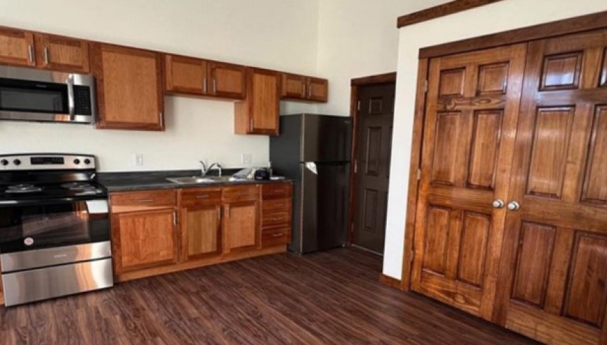 Kitchen with new wood cabinets and stainless steel appliances.