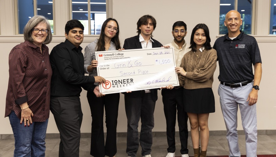 Students and Judges standing with a large check for second place