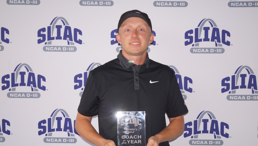 Coach Connor McKay holding a glass trophy