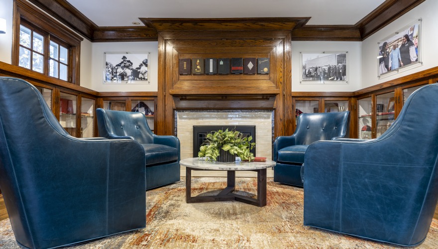 living room with 4 blue chairs and fireplace