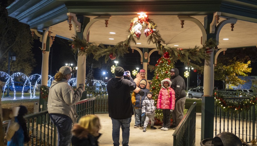Family taking a photo at Jingle Bell Holiday event 