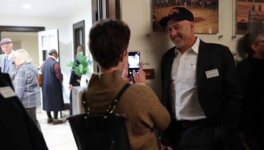 Person Taking a photo of someone with phone in front of there room at Hannah House