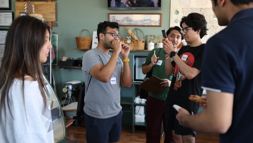 Parikshit eats something delicious at Saints Rest with his IPOP students