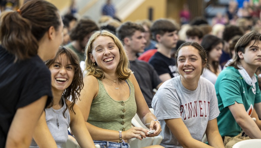 students sitting in gym smiling at eachother