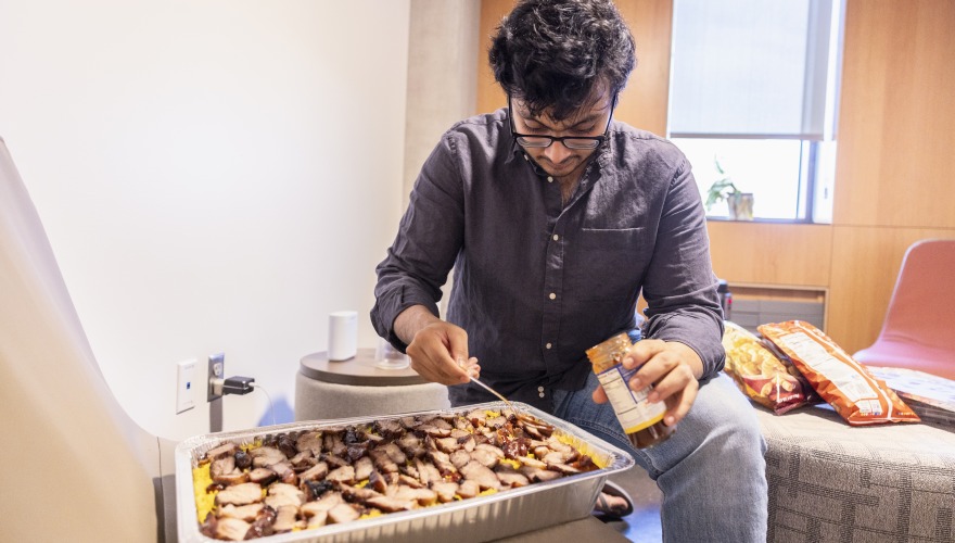 Parikshit prepares a dish from his home country, India, for the Food Bazaar