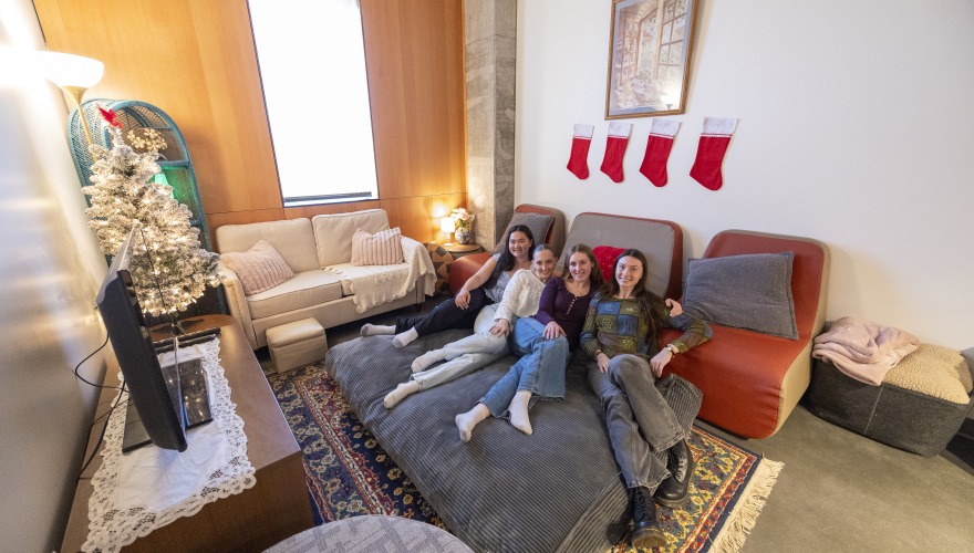 Four young woman relax on a giant beanbag chair