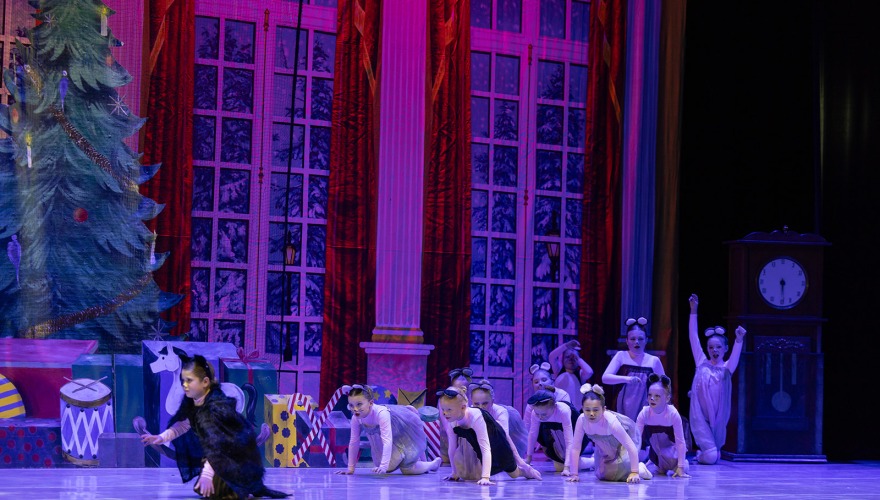 little girls crawling in on stage in mice costumes 