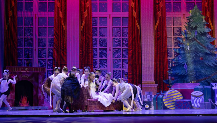 little girls performing nutcracker on dark stage