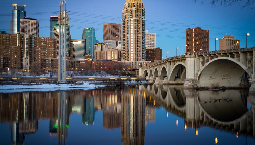 Skyline of Minneapolis, Minnesota against a bright blue sky