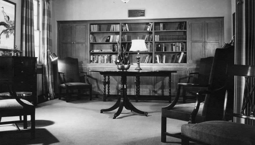 A vintage black and white photo of the lounge in Loose Hall