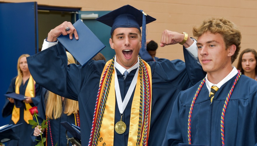 James celebrates his high school graduation in cap and gown