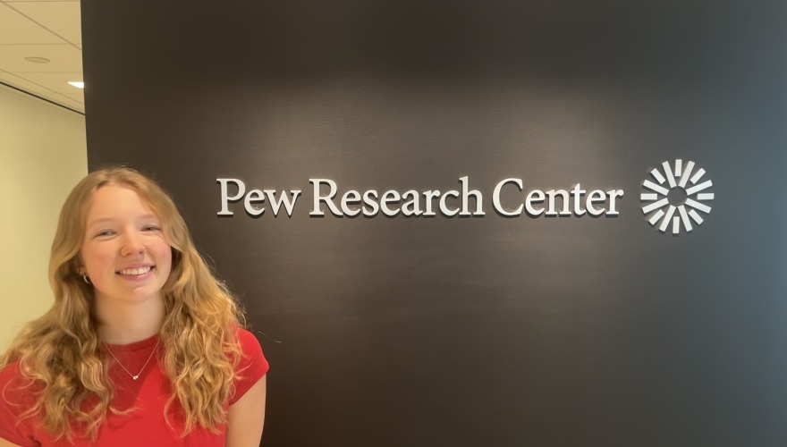 Skylar poses next to the Pew Research Center sign