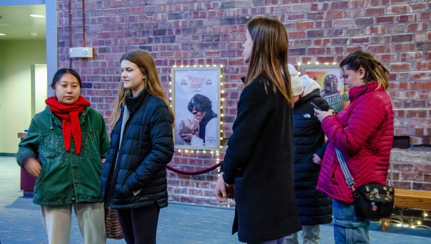 people standing outside the theater