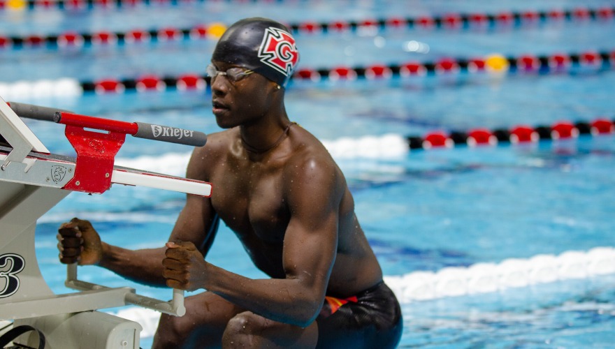 Men's swimmer gets set for the start of a backstroke race